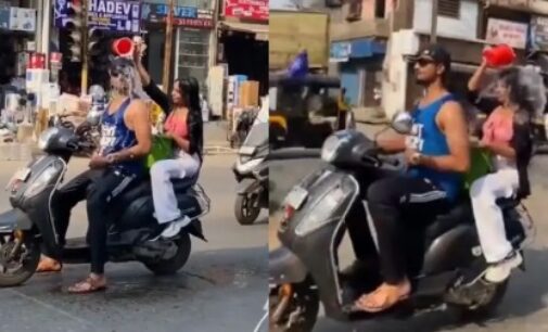 Beat the heat! Boy & girl take bath while riding scooter on road, watch